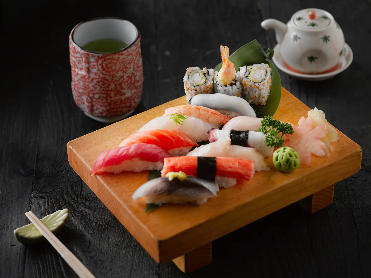 Assorted nigiri sushi platter with green tea and teapot at Sushi Kai, a Japanese Restaurant in Tallahassee