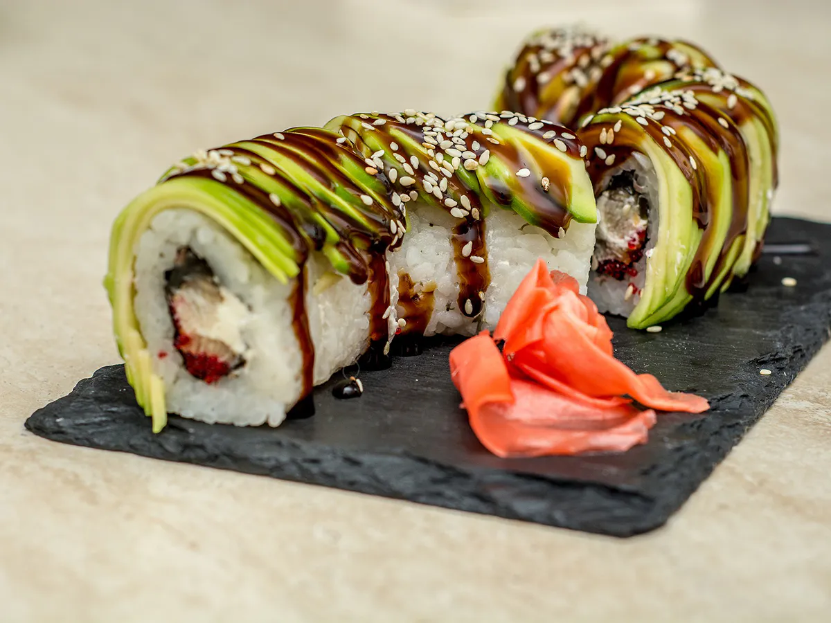Avocado-topped sushi rolls with eel sauce and sesame seeds at Sushi Kai, a Japanese Restaurant in Tallahassee